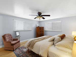 Bedroom with ceiling fan and wood-type flooring