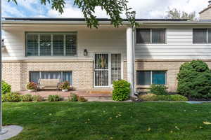 View of front facade featuring a patio and a front lawn