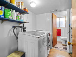 Clothes washing area featuring separate washer and dryer