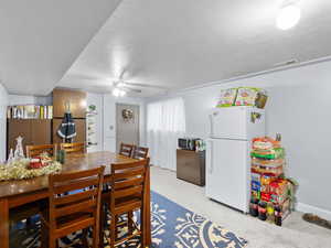 Dining room with a textured ceiling and ceiling fan