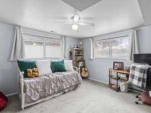 Bedroom featuring ceiling fan and carpet floors