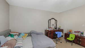 Bedroom with light colored carpet