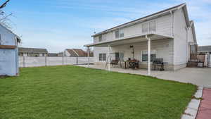 Back of house featuring a patio and a lawn