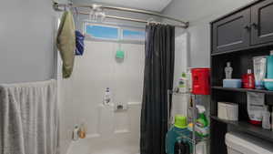 Bathroom featuring shower / bath combo and toilet