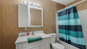 Full bathroom with vanity, toilet, and shower / bath combo