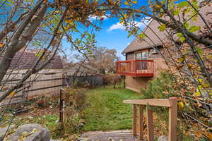 View of yard featuring a wooden deck