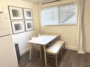 Dining room with dark hardwood / wood-style floors