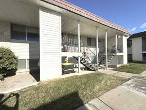 Property entrance featuring a yard and a porch