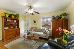 Living room featuring light hardwood / wood-style flooring and ceiling fan