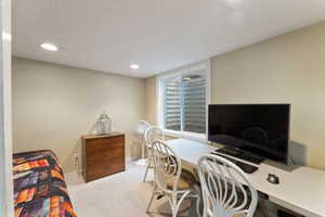 Carpeted bedroom featuring a textured ceiling