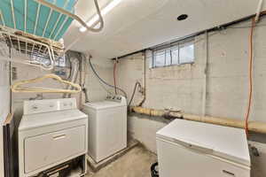 Clothes washing area featuring washing machine and clothes dryer