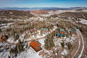 Snowy aerial view featuring a mountain view