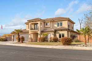 Mediterranean / spanish-style house featuring a balcony and a garage