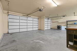 Garage with a garage door opener and washer / dryer