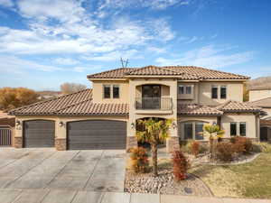 Mediterranean / spanish-style house featuring a garage and a balcony