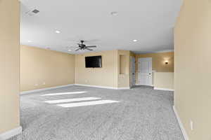 Unfurnished living room with carpet flooring and ceiling fan