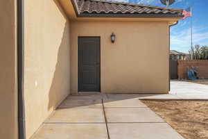 Property entrance with a patio area