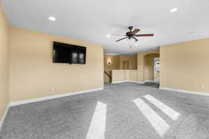 Interior space with carpet flooring and ceiling fan