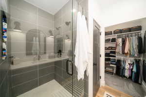 Bathroom featuring LVP flooring and an enclosed shower