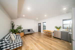 Living room with plenty of natural light, sink, and light LVP flooring