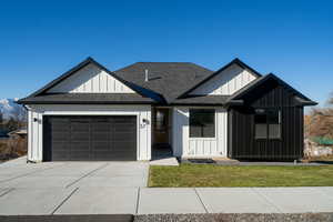 View of front of house with a front lawn and a garage