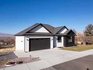 View of front of home featuring a mountain view and a garage