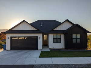 View of front of house featuring a yard and a garage