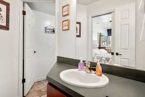 Bathroom featuring tile patterned floors, vanity, and a textured ceiling