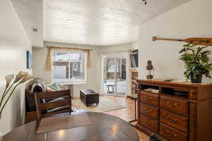 Dining room with a textured ceiling and light wood-type flooring