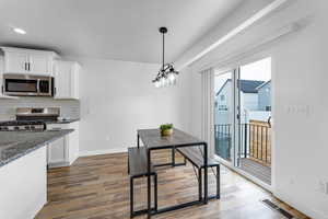 Dining space featuring dark hardwood / wood-style flooring and a textured ceiling