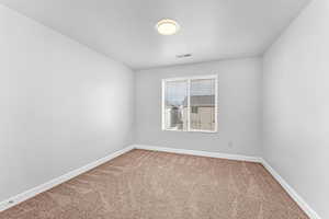 Unfurnished room with carpet