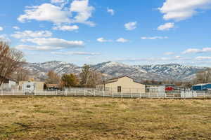 View of yard with a mountain view, an outbuilding, and a rural view