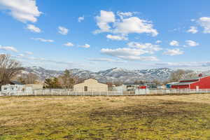 View of yard featuring a mountain view, a rural view, and an outdoor structure