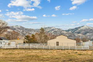 View of yard featuring a mountain view, a rural view, and an outdoor structure