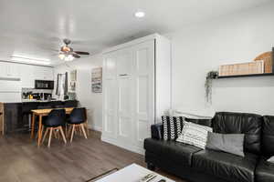 Living room featuring a textured ceiling, dark hardwood / wood-style floors, and ceiling fan