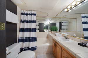 Full bathroom with shower / tub combo, vanity, and toilet