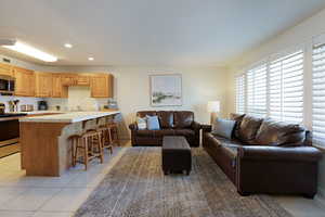 Living room with light tile patterned flooring