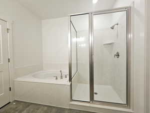 Bathroom featuring hardwood / wood-style flooring and independent shower and bath