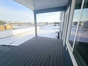 Snow covered deck with a mountain view