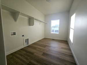 Washroom with hookup for an electric dryer, dark hardwood / wood-style floors, and hookup for a washing machine