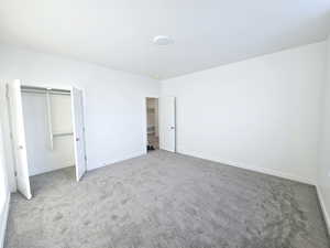 Unfurnished bedroom with carpet and a closet