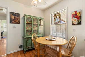 Dining area featuring a textured ceiling, hardwood / wood-style flooring, and ceiling fan