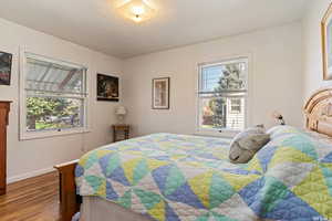 Bedroom with hardwood / wood-style floors and a textured ceiling