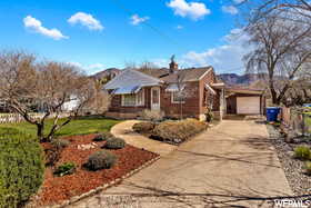 View of front of house with a mountain view and a garage