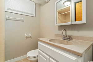 Bathroom with tile patterned flooring, a shower, vanity, and toilet