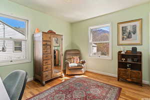 Living area with light hardwood / wood-style floors and a textured ceiling