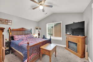 Bedroom featuring light colored carpet, ceiling fan, and lofted ceiling