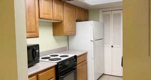 Kitchen featuring black appliances and light tile patterned flooring