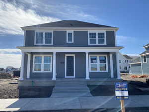 American foursquare style home with a porch