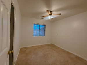 Spare room featuring ceiling fan and a textured ceiling